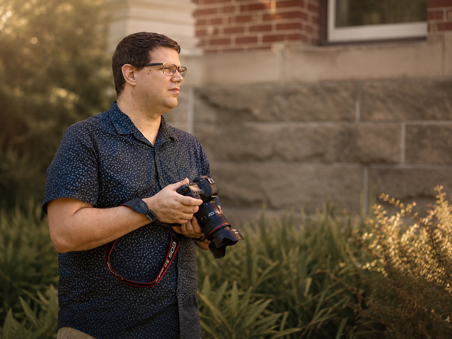 Beau Whately standing outdoors with his camera in warm Australian light