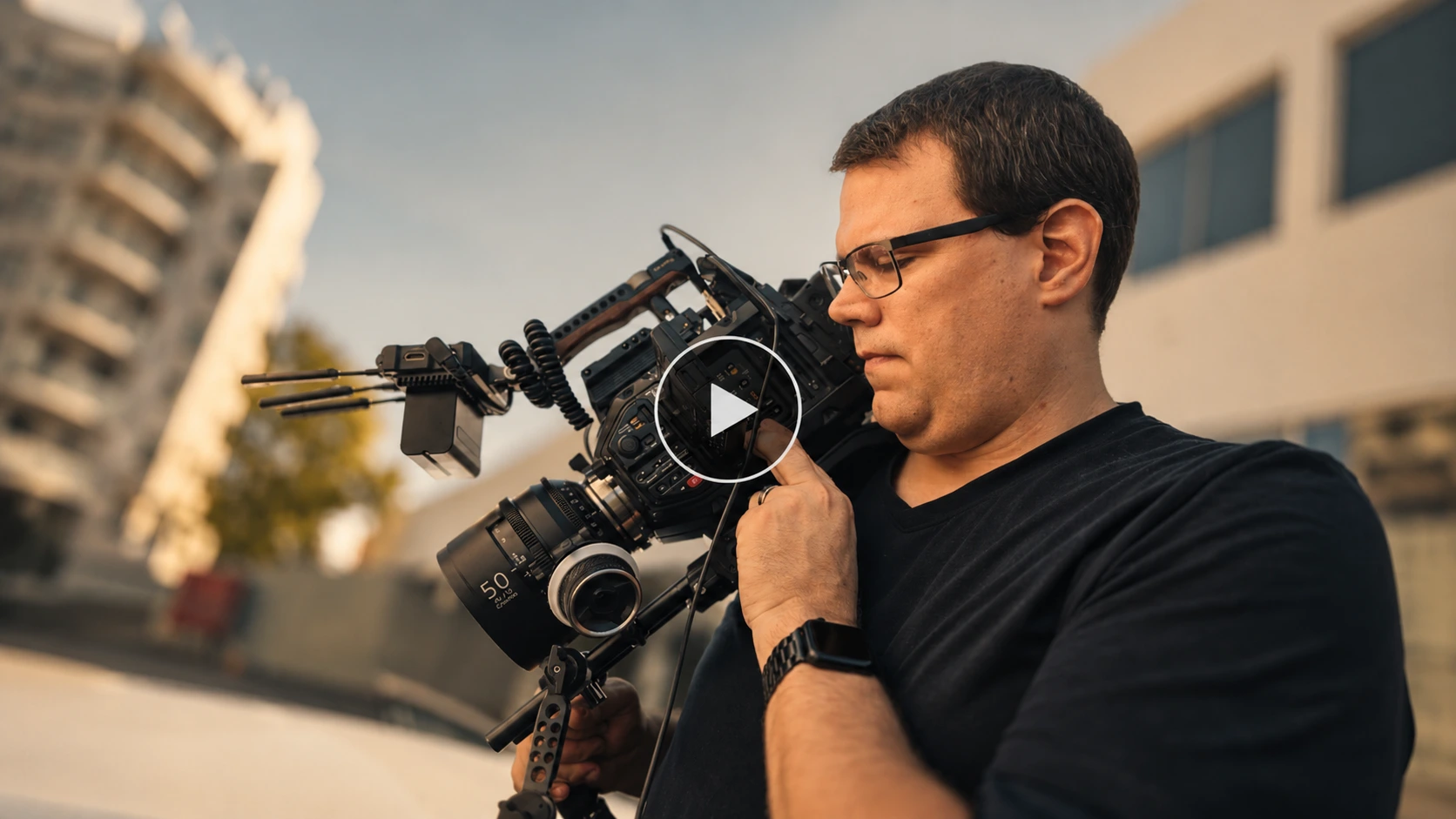Beau Whately operating a cinema camera with a play button overlay